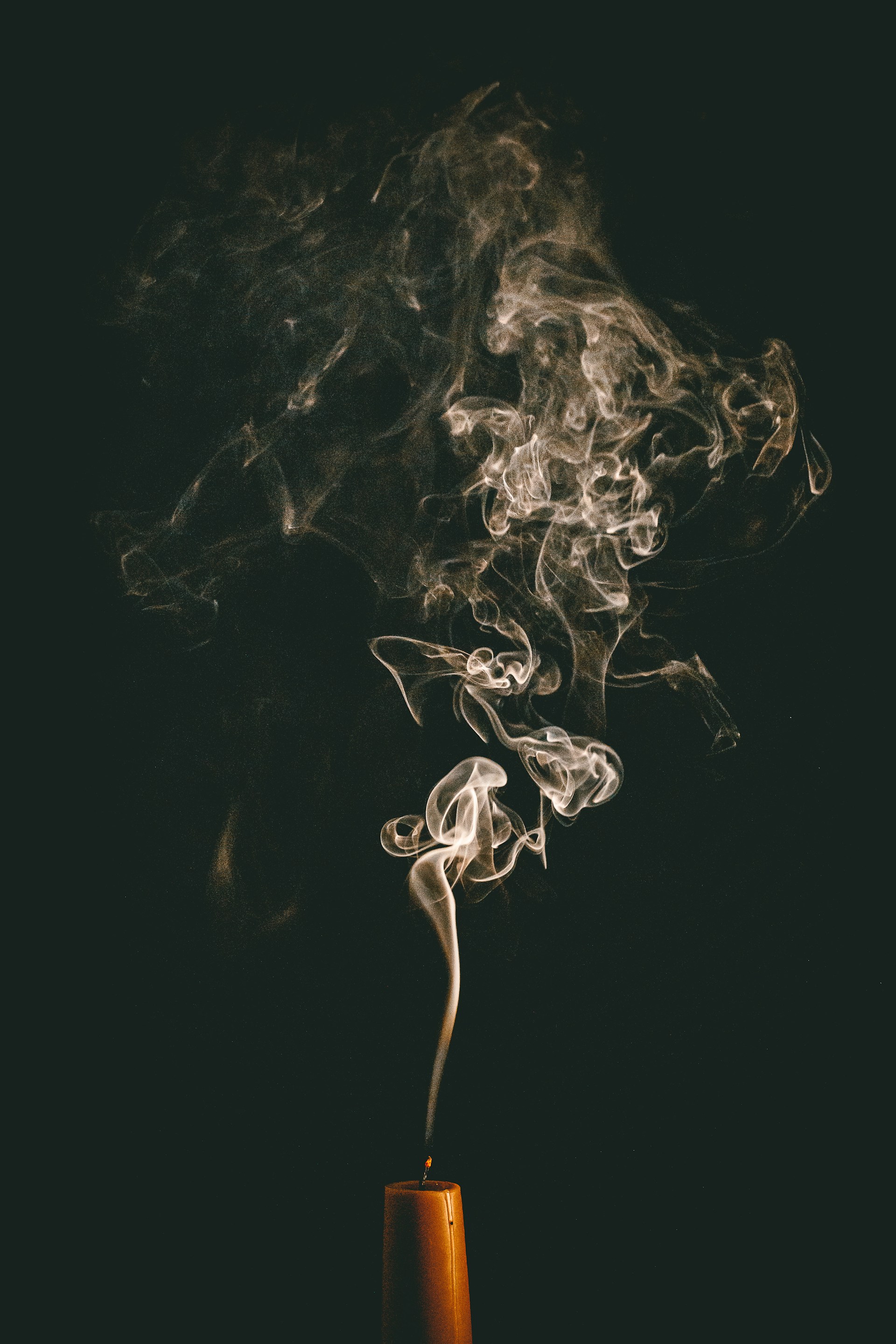 a cup filled with smoke sitting on top of a table
