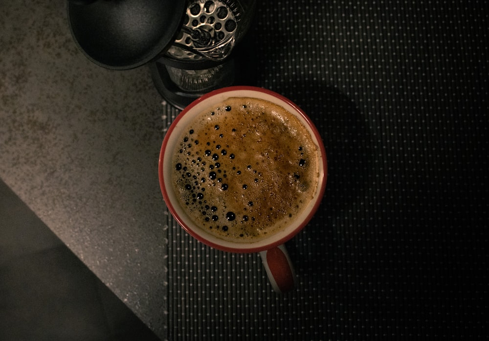 a cup of coffee sitting on top of a table