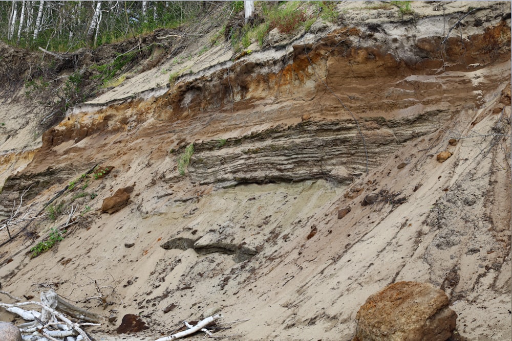 a group of rocks sitting on the side of a cliff