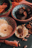 Assorted dry fruits like almonds, pistachios, and walnuts artfully arranged on a natural linen cloth.