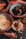An assortment of premium nuts and dry fruits neatly arranged in small bowls on a rustic wooden board.