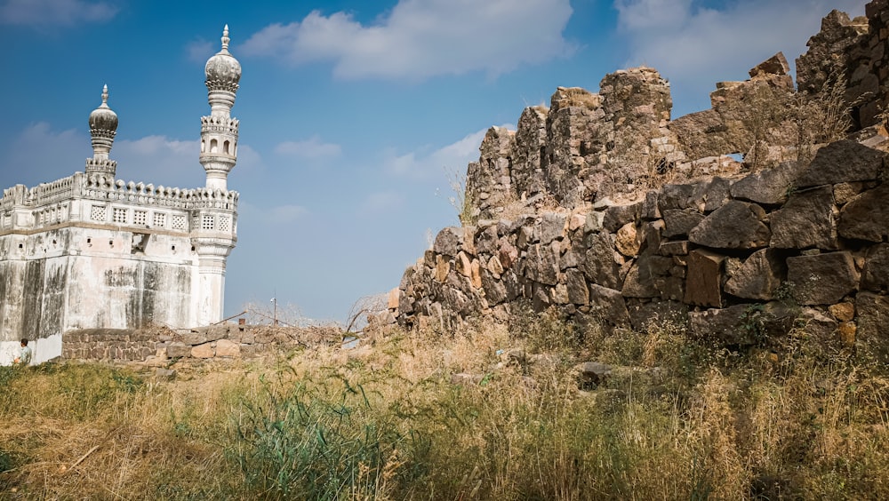 a tall white building sitting on top of a rocky hillside