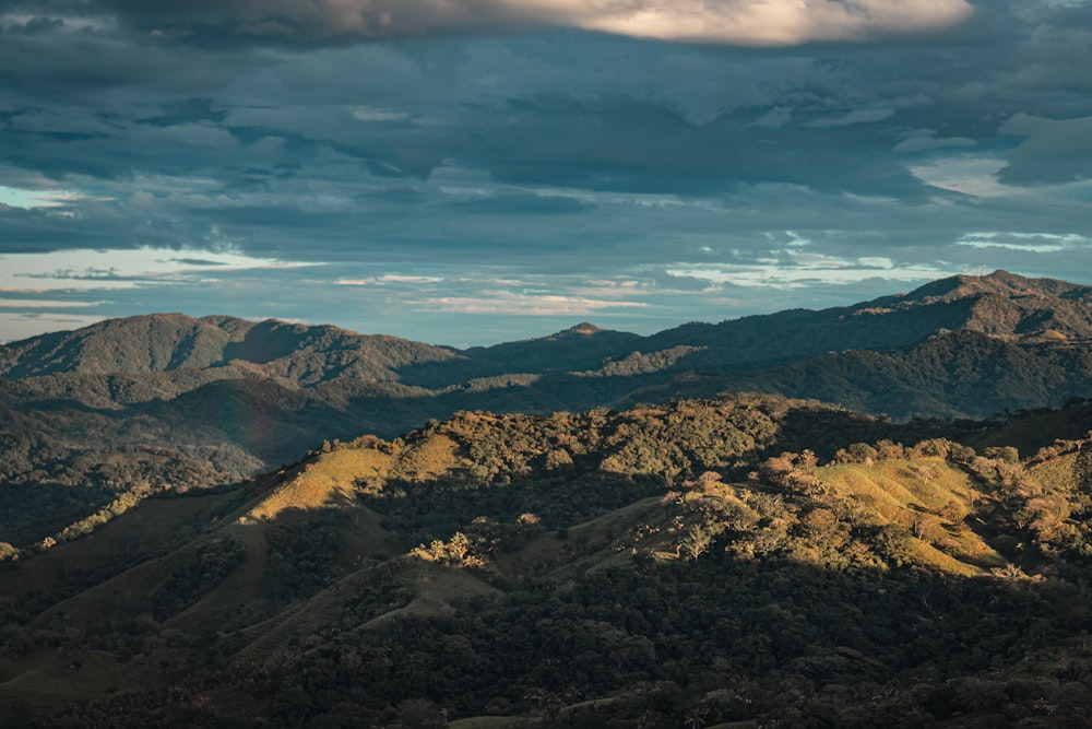 a view of a mountain range under a cloudy sky