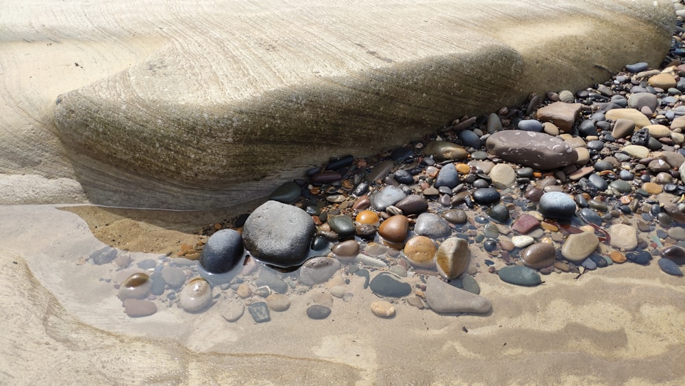 some rocks and gravel on a beach