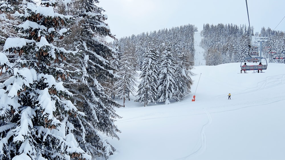 a person riding a ski lift on a snowy mountain