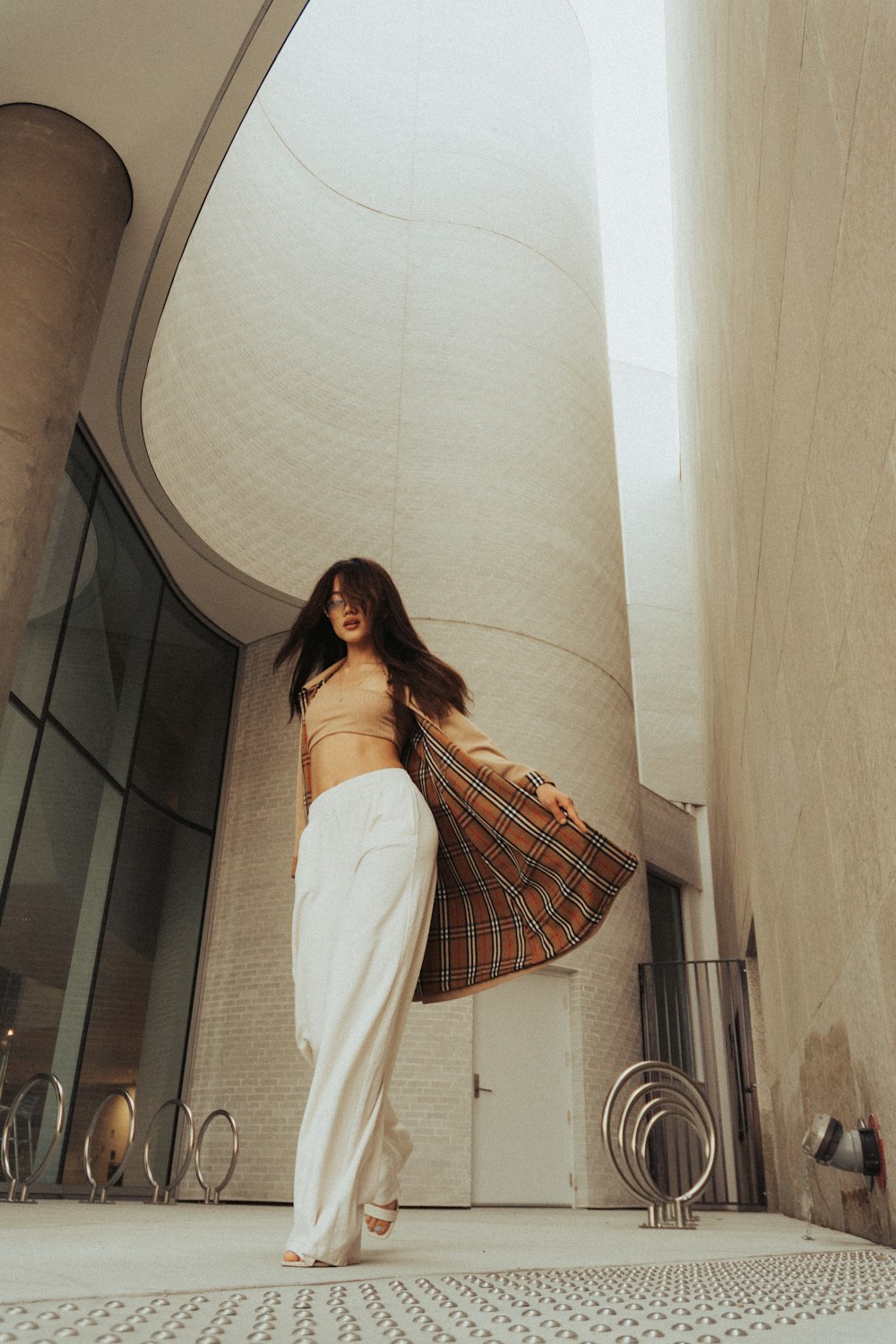 a woman is walking down the street in a skirt