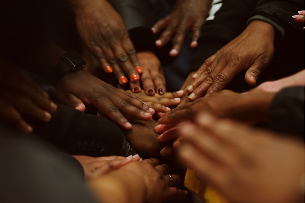 a group of people with their hands together