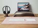 a laptop computer sitting on top of a wooden desk
