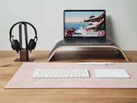 a laptop computer sitting on top of a wooden desk