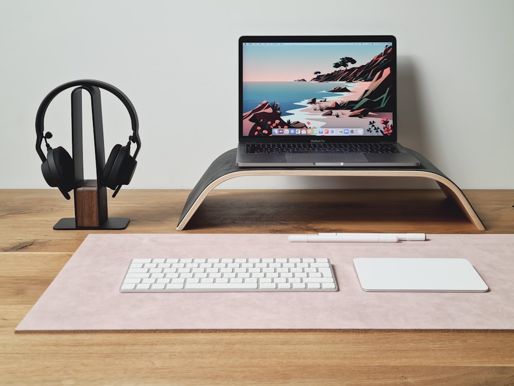 a laptop computer sitting on top of a wooden desk