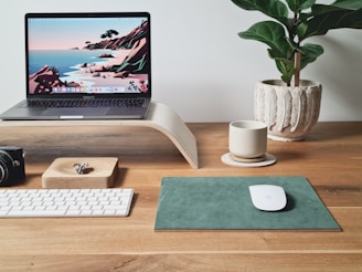 A neat desk with organized financial documents and a laptop displaying bookkeeping software.