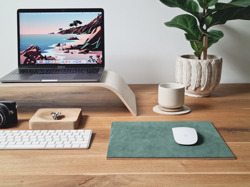 a laptop computer sitting on top of a wooden desk