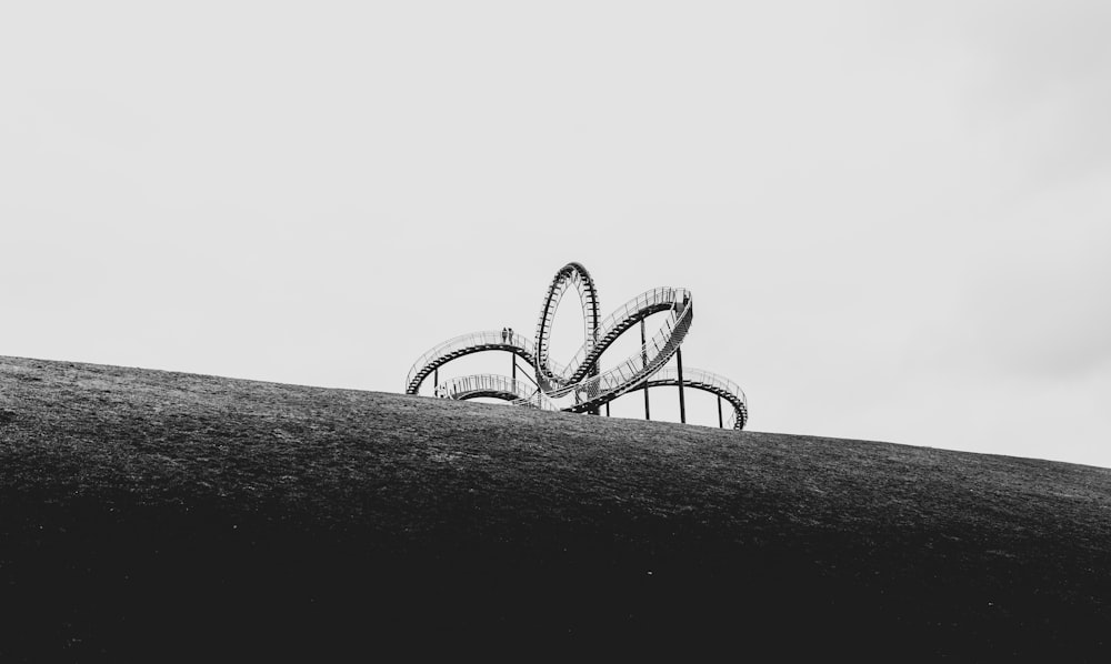 a black and white photo of a roller coaster