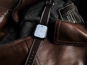 a close up of a watch on a leather bag