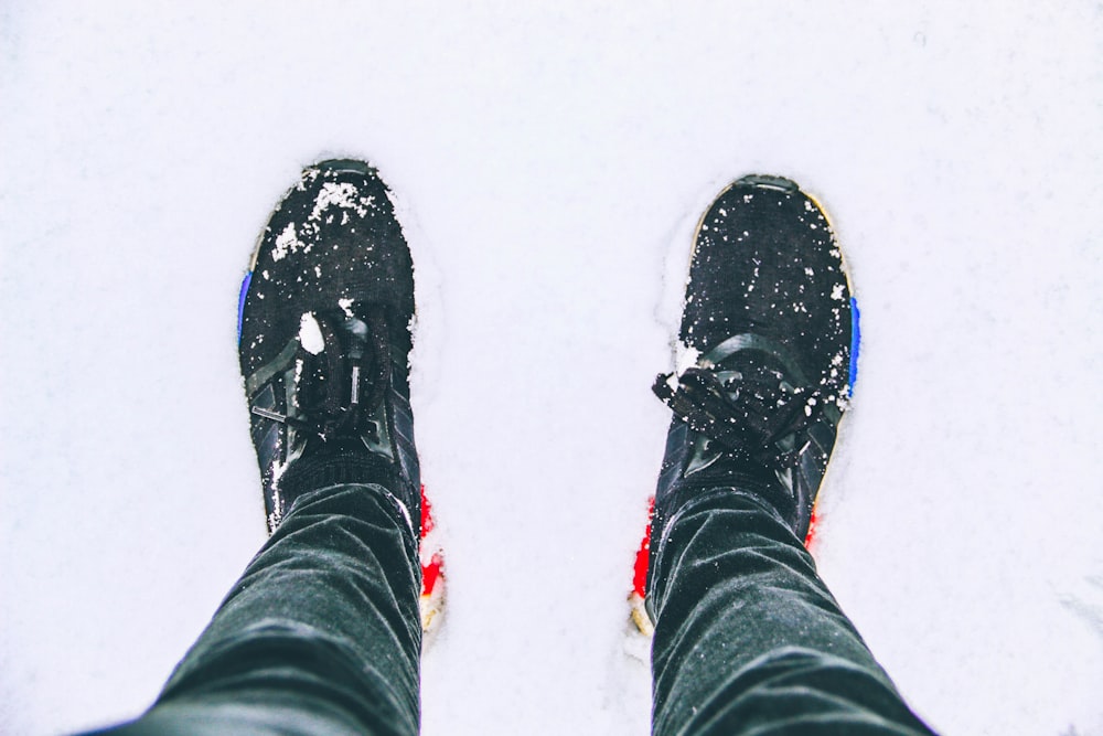 a person standing in the snow wearing skis