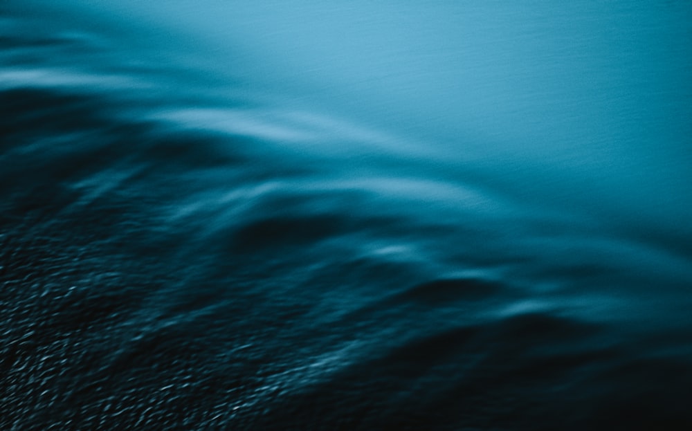 a black and white photo of a wave in the ocean