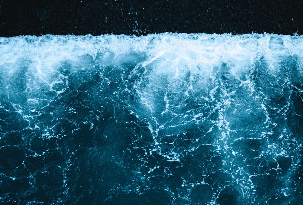 a large body of water with a wave coming in