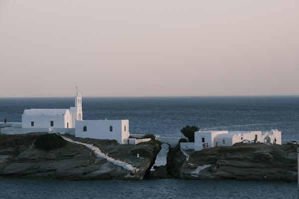 A small white church on a rocky outcropping — Sifnos, Greece