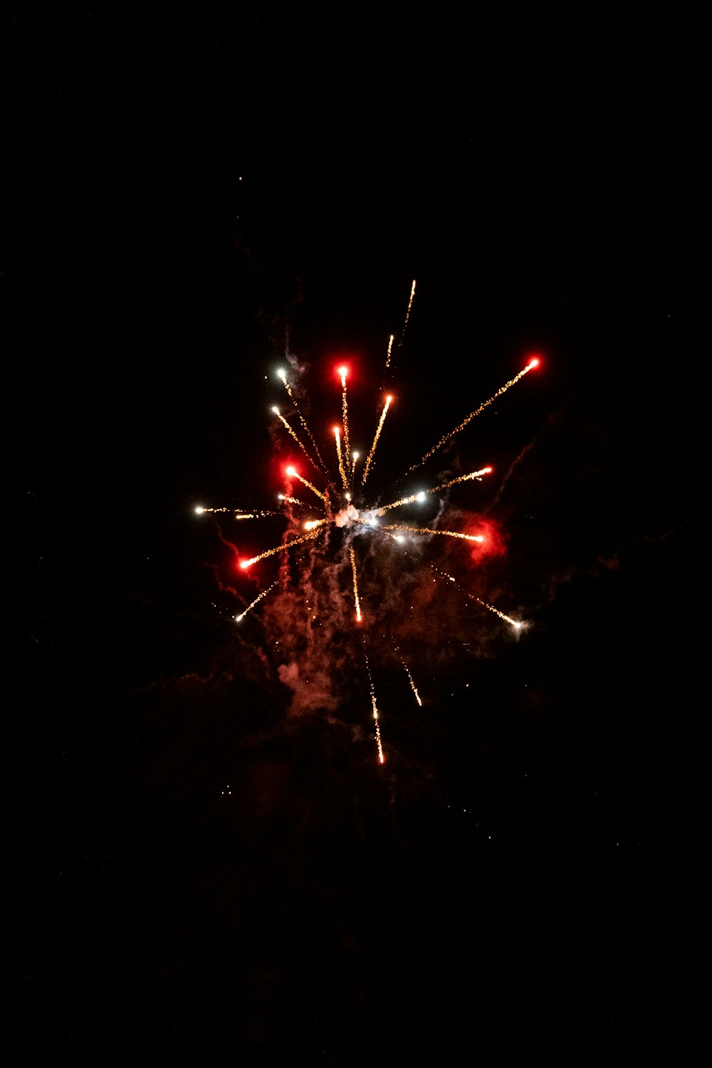 a fireworks is lit up in the dark sky