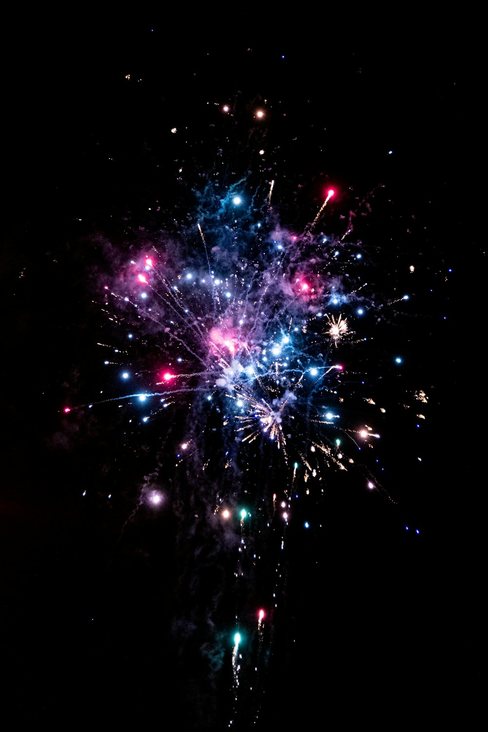 a colorful fireworks is lit up in the night sky