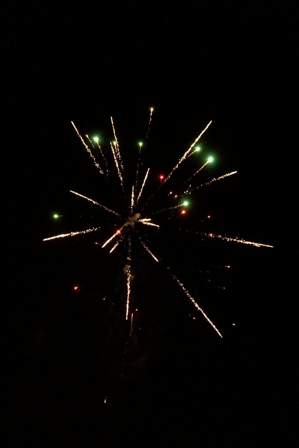 a fireworks is lit up in the dark sky