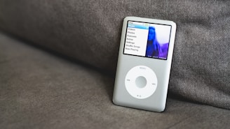 an ipod sitting on top of a couch