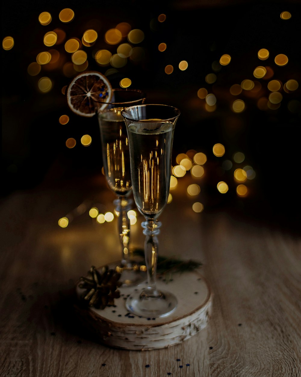 two glasses of champagne sitting on top of a wooden table