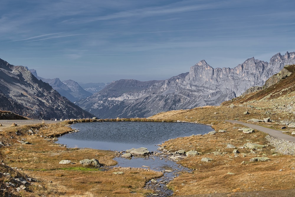 a small lake in the middle of a mountain range