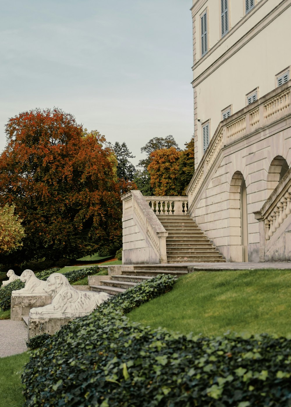 a building with a staircase and a statue in front of it