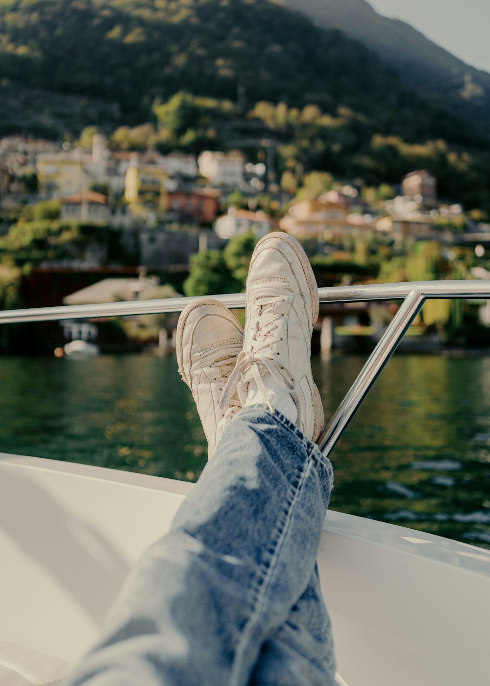 a person's feet resting on the edge of a boat