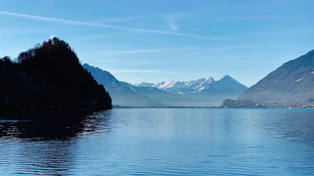 a body of water with mountains in the background