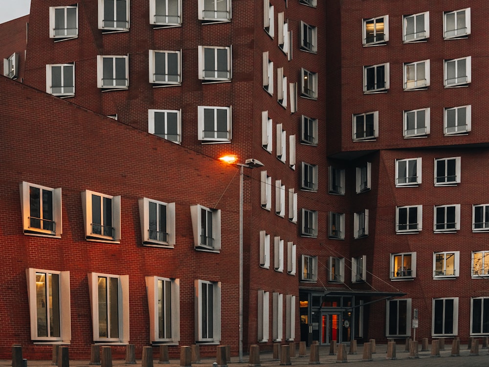 a red brick building with a street light in front of it