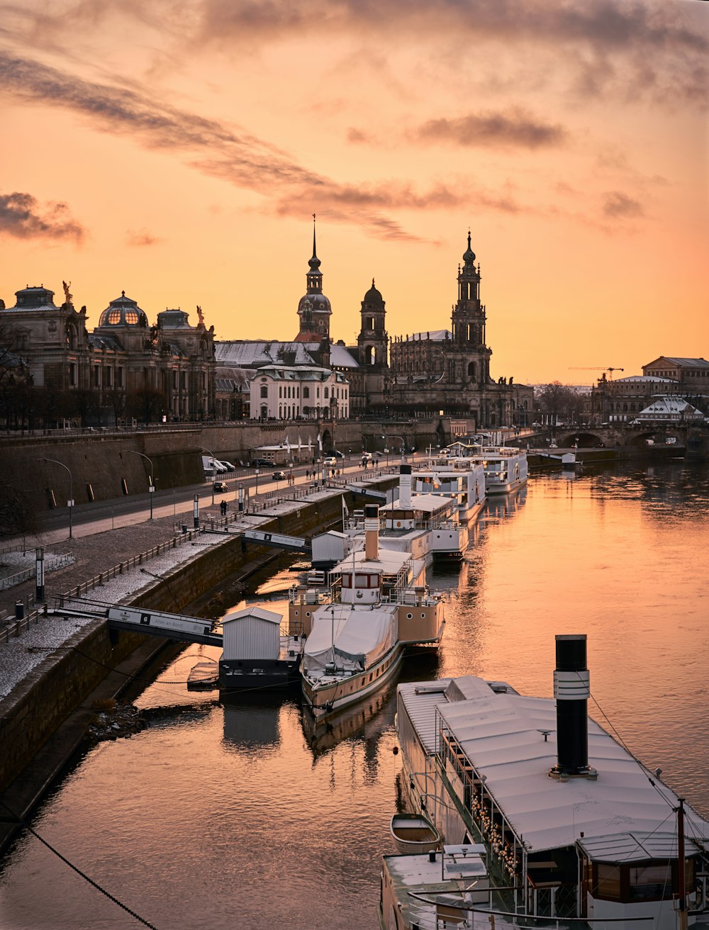 a river filled with lots of boats under a cloudy sky