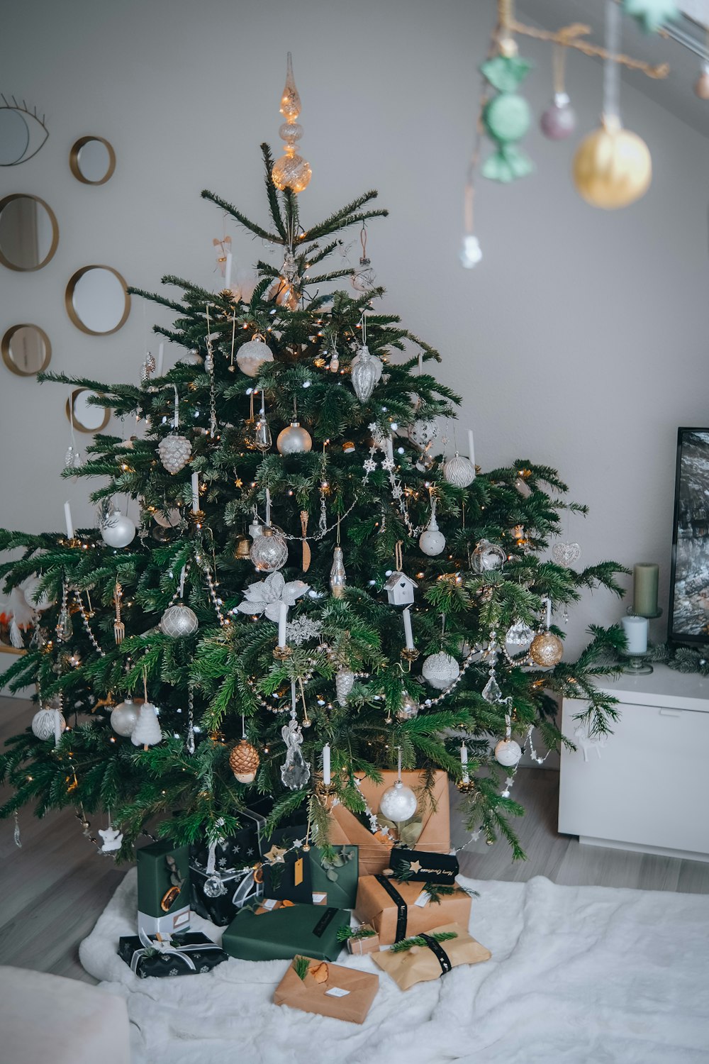 a small christmas tree with presents under it