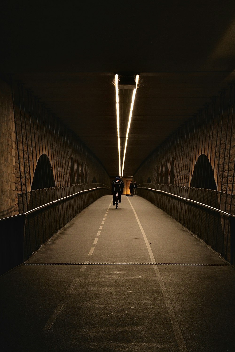 a couple of people that are walking across a bridge