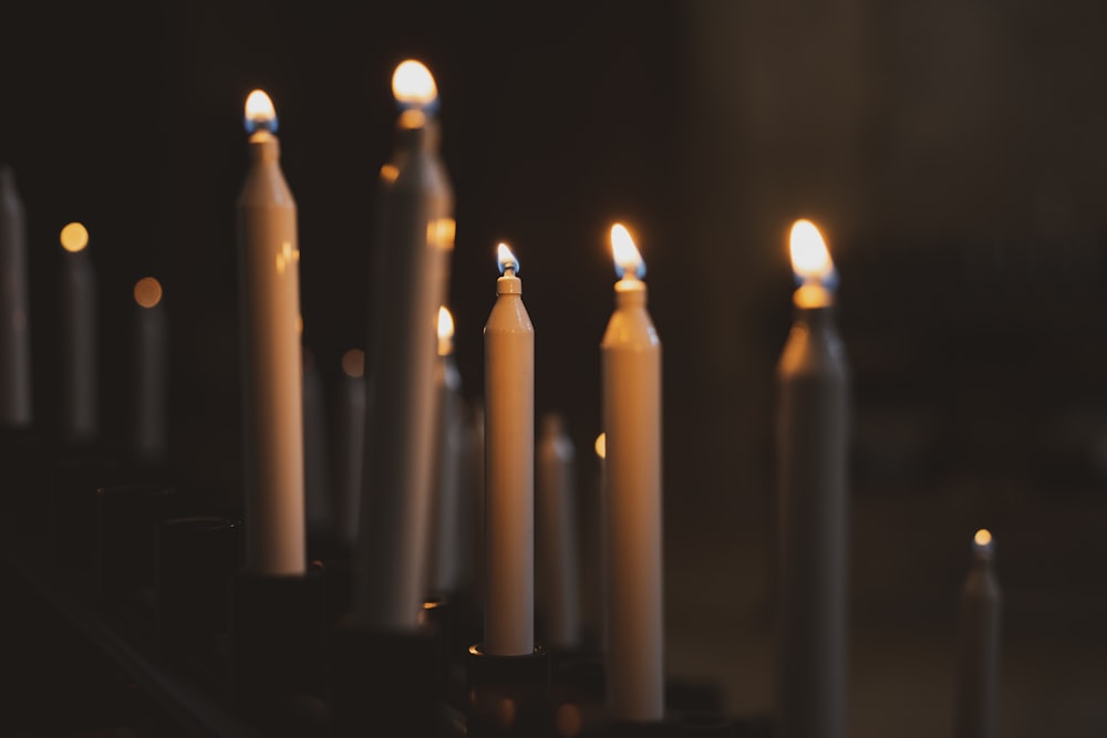 a group of lit candles sitting on top of a table