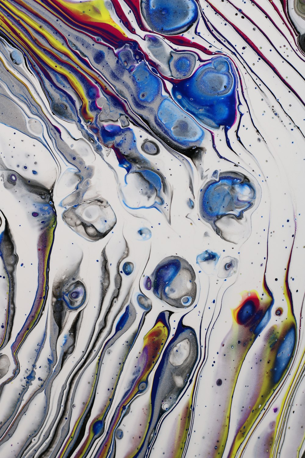 a close up of an abstract painting with water drops