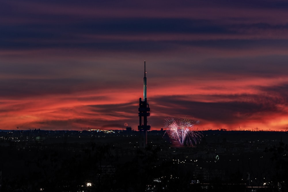 fireworks are lit up in the sky above a city