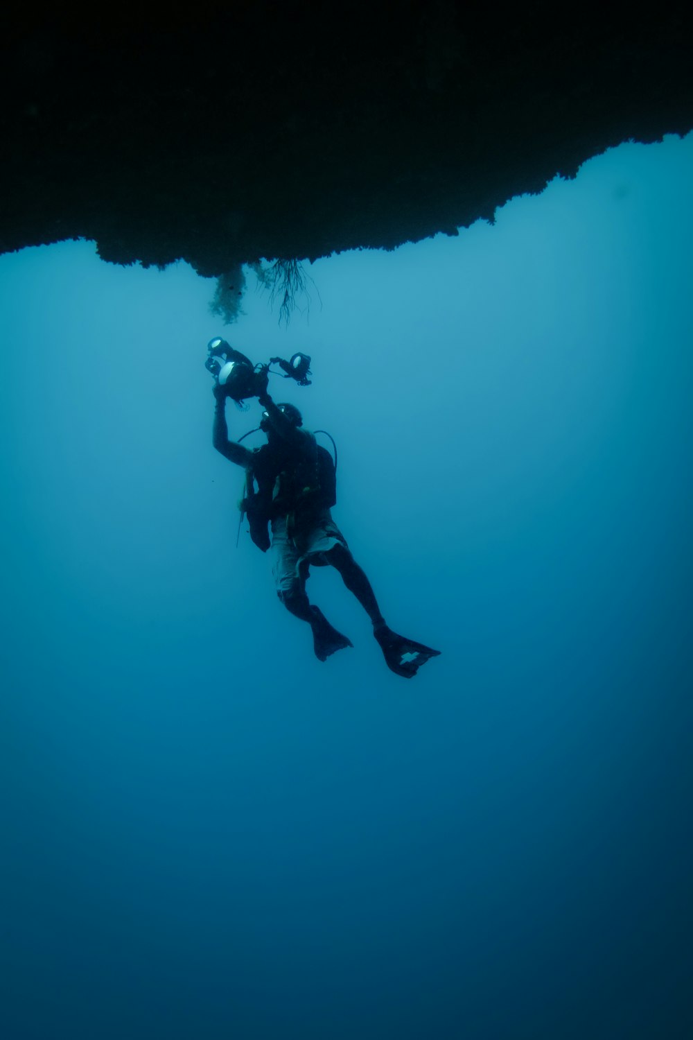 a person in a wet suit diving in the ocean