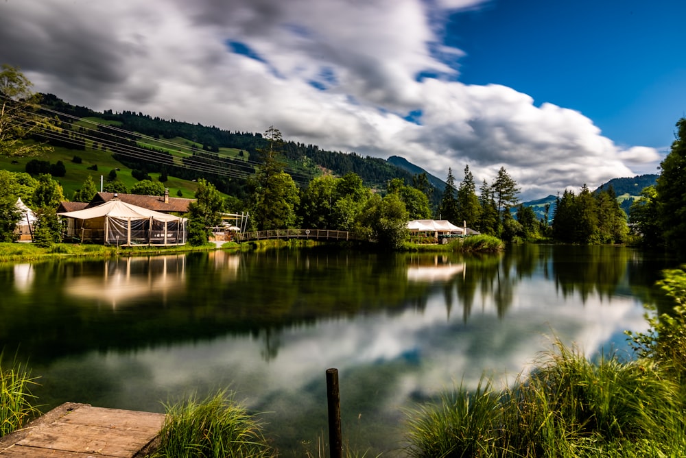 a body of water surrounded by a lush green hillside