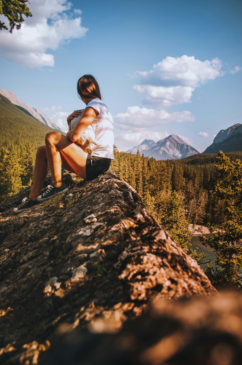 a person sitting on top of a large rock