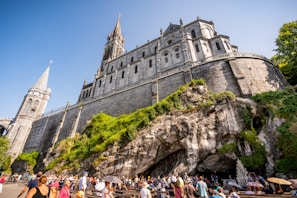 a group of people standing in front of a castle