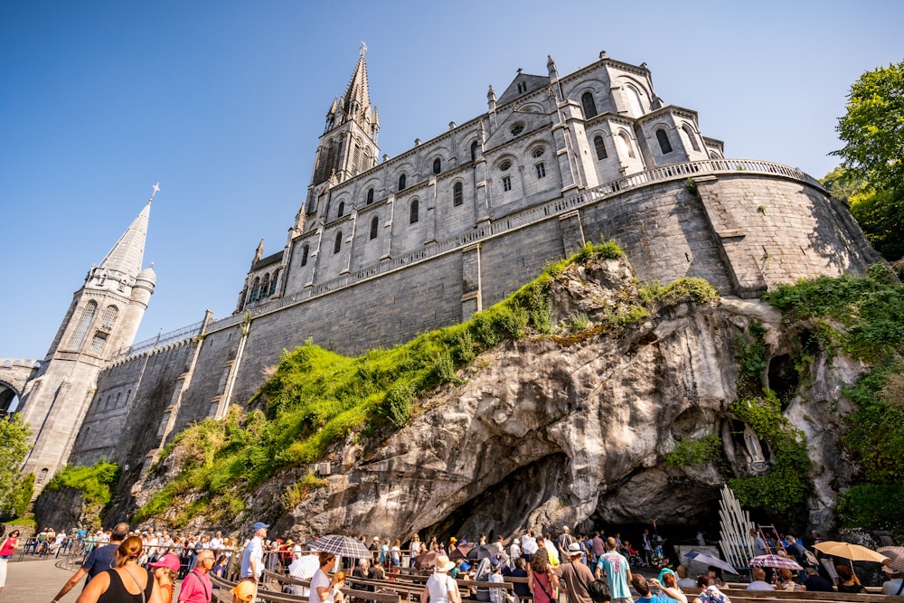 a group of people standing in front of a castle