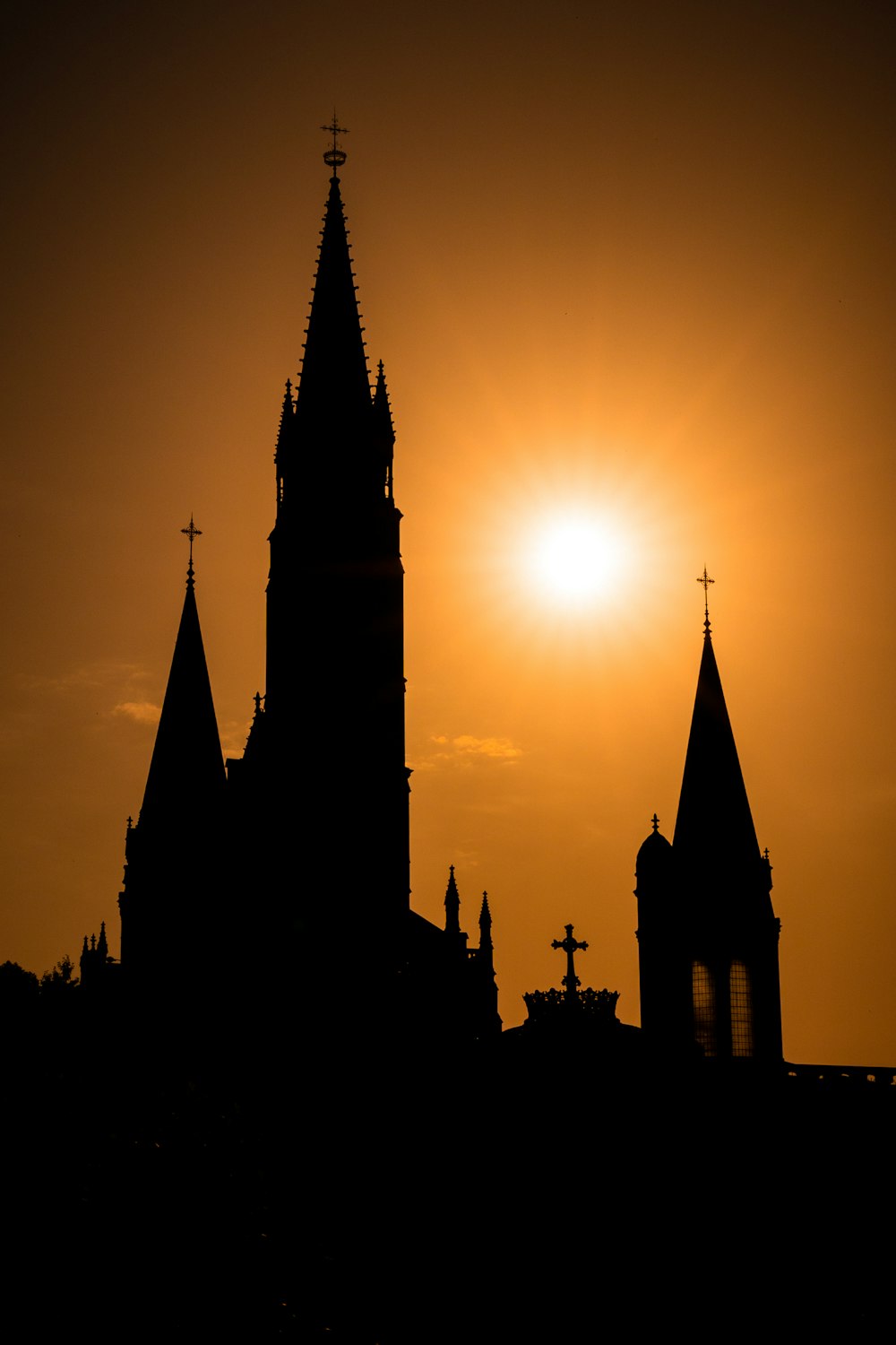 the sun is setting behind a church steeple