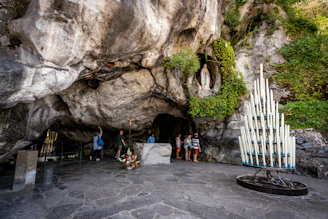a group of people standing inside of a cave