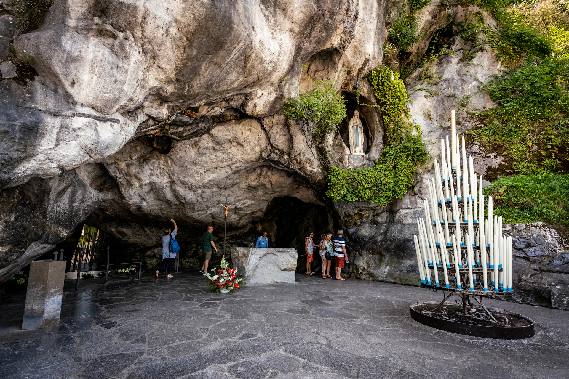 a group of people standing inside of a cave