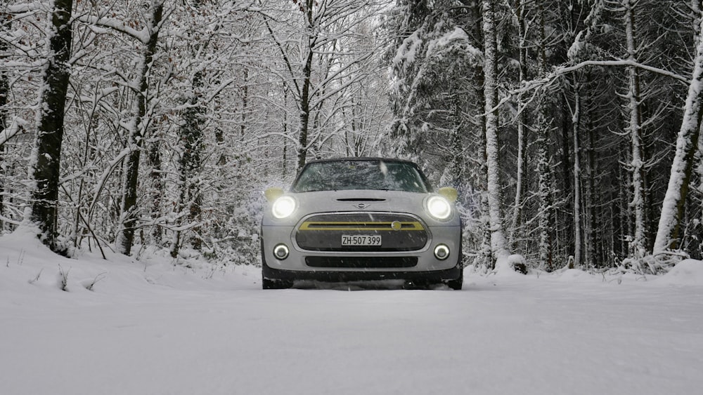 a car driving down a snow covered road