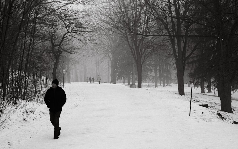 a person walking down a snow covered road