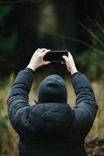 a person taking a picture with a cell phone