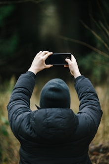 a person taking a picture with a cell phone